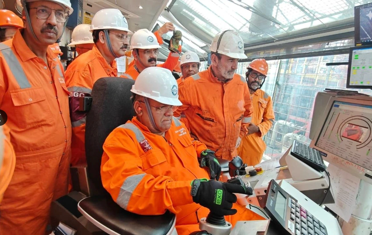 EXO-branded gloves at the drillship controls during ONGC leadership’s documented visit